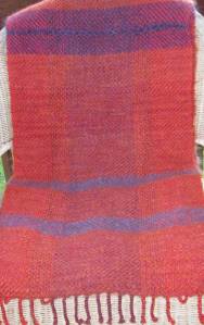 mostly orange shawl with horizontal purple stripes, and center panel faintly purple.