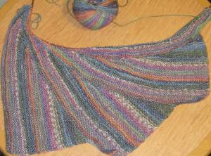 three variegated knitted triangles.