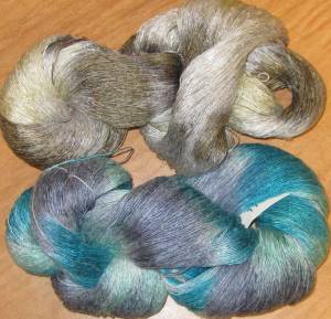 two skeins, top is white, tan and gray, botom is turquoise, gray and lavender.