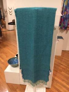 aqua shawl hanging at end of a section of the show